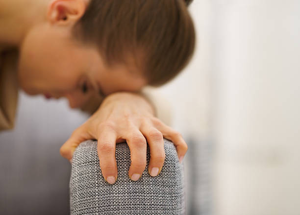 istock stressed young housewife sitting on couch 478208617