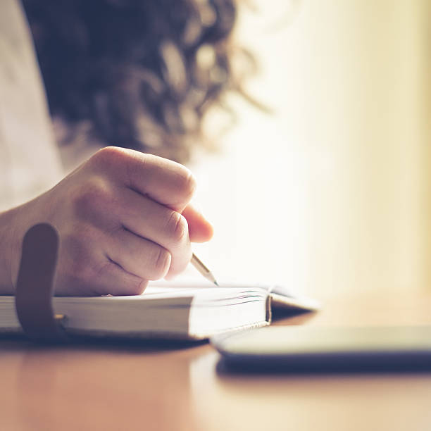 istock beautiful woman at home writing and working 478209273