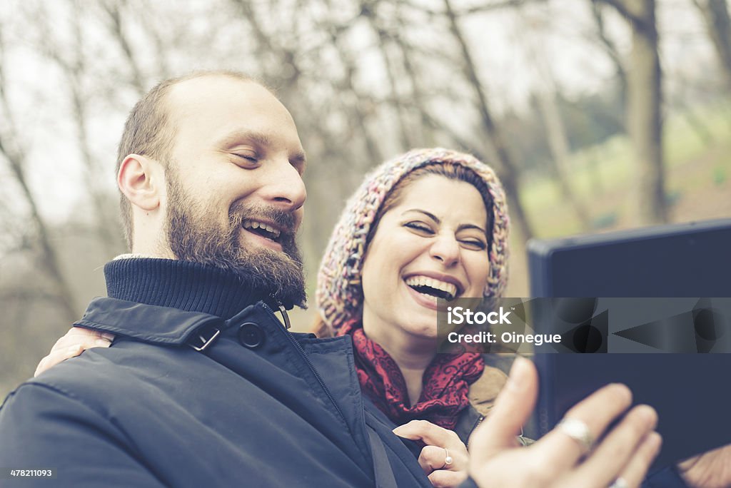 couple in love selfie couple in love selfie at the park winter Adult Stock Photo