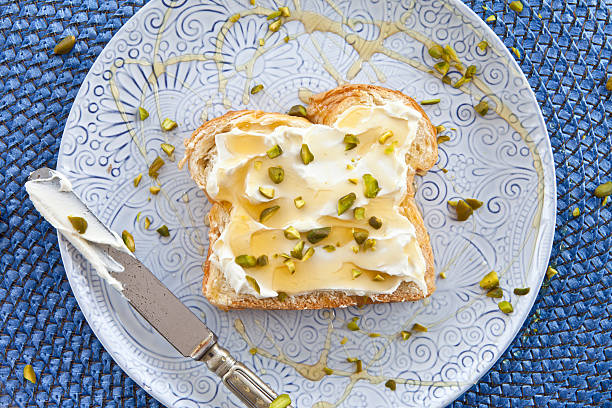 Brioche with cream cheese and honey stock photo