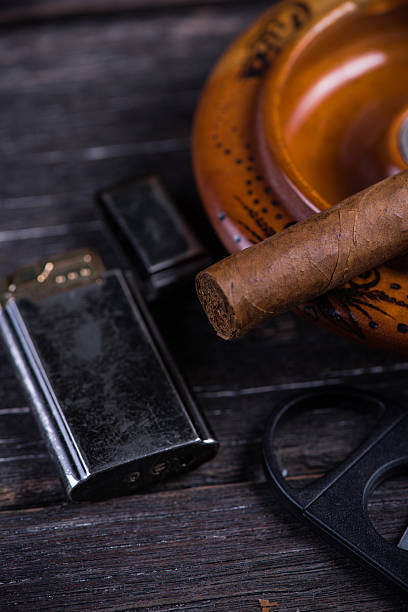 istock Cuban cigar in ashtray with lighter and cutter 478211732