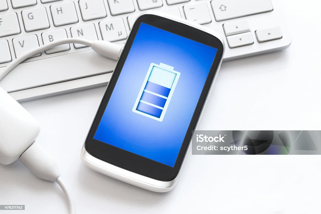 Charging of mobile phone. Phone charging with energy bank. 2015 Stock Photo