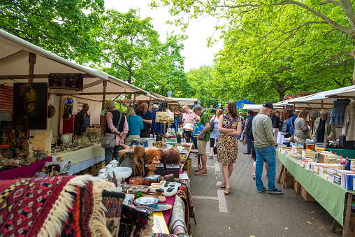 Berlin, Germany - June 14, 2015: Flea market in Berlin - city part Fehrbellin at a weekend in June. A lot of privat sellers offers old goods, artwork and books. Many people coming and looking for interested things