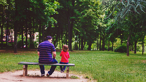 istock father and son sitting on the bench 478219230