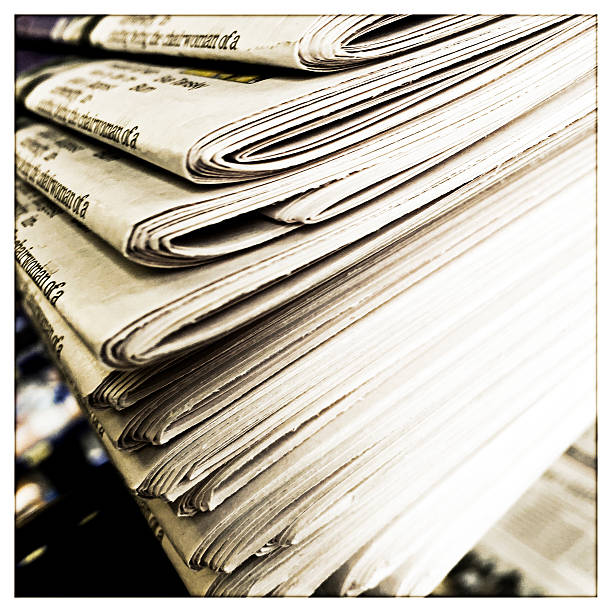 istock Newspapers in a Stack at a News Stand 478219318