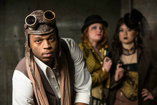 Steampunk Trio Young Steam Punks PosIng in Underground Lair steampunk pistol pictures stock pictures, royalty-free photos & images