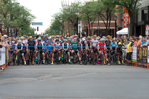 Minneapolis, Minnesota, USA – June 19, 2015: Pro cyclists and spectators at starting line for Uptown Criterium or Stage Four of prestigious 2015 North Star Grand Prix pro cycling event in Minneapolis.