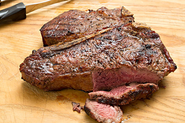 Barbecued Steak A high angle extreme close up shot of a barbecued Porterhouse steak porterhouse steak stock pictures, royalty-free photos & images