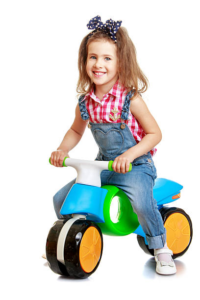 istock Funny girl riding on a plastic children's Bicycle 478222888