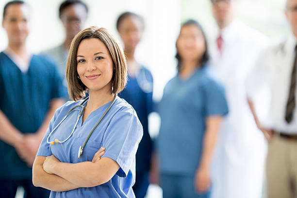 istock Nurse Standing with Medical Professionals 478223962