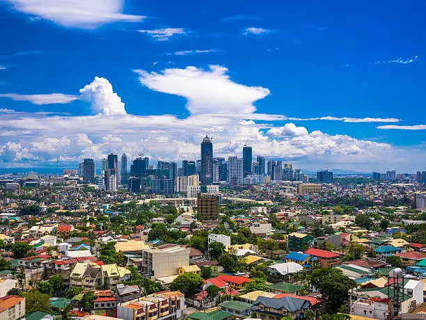 Manila city by Day showing Ortigas and suburban buildings in the foreground With the Bonafacio Global city centred in the background
