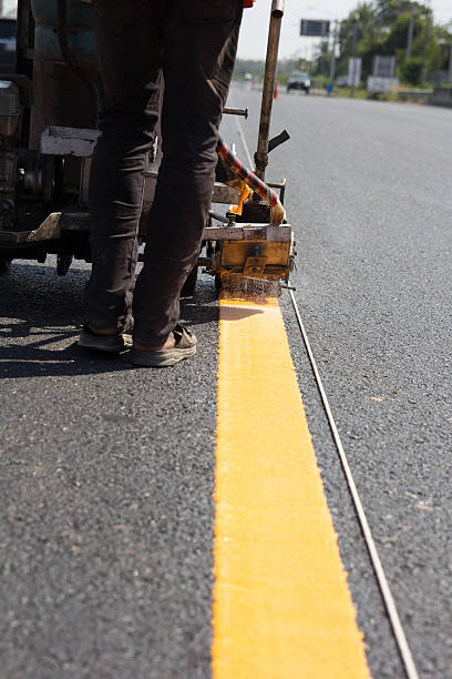 istock Machine eject and worker on road and traffic sign painting 478224798