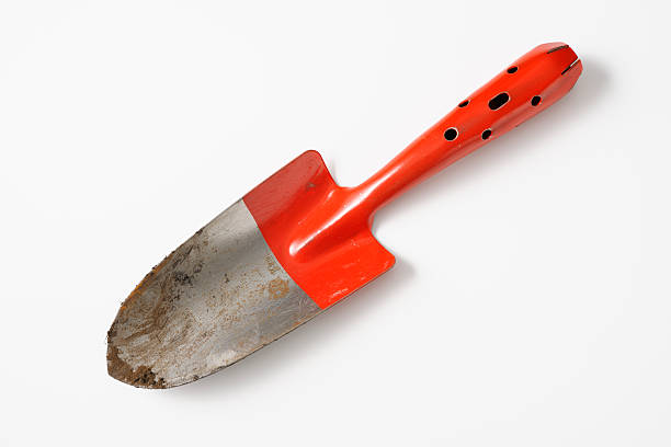 Isolated shot of red dirty shovel on white background Red dirty shovel isolated on white background. trowel shovel gardening equipment isolated stock pictures, royalty-free photos & images