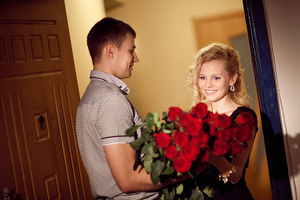 man gives roses to a girl stock photo