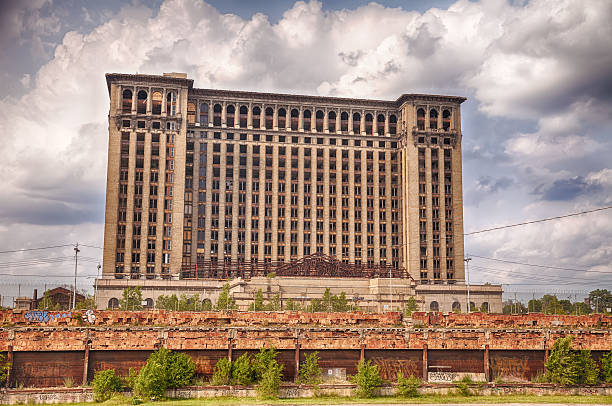 Michigan Central Station Detroit, USA - June 9, 2015:  Michigan Central Station was the main intercity passenger rail depot for Detroit, Michigan until the historic landmark was closed down and abandoned. This view from the back shows the railway tracks. detroit ruins stock pictures, royalty-free photos & images