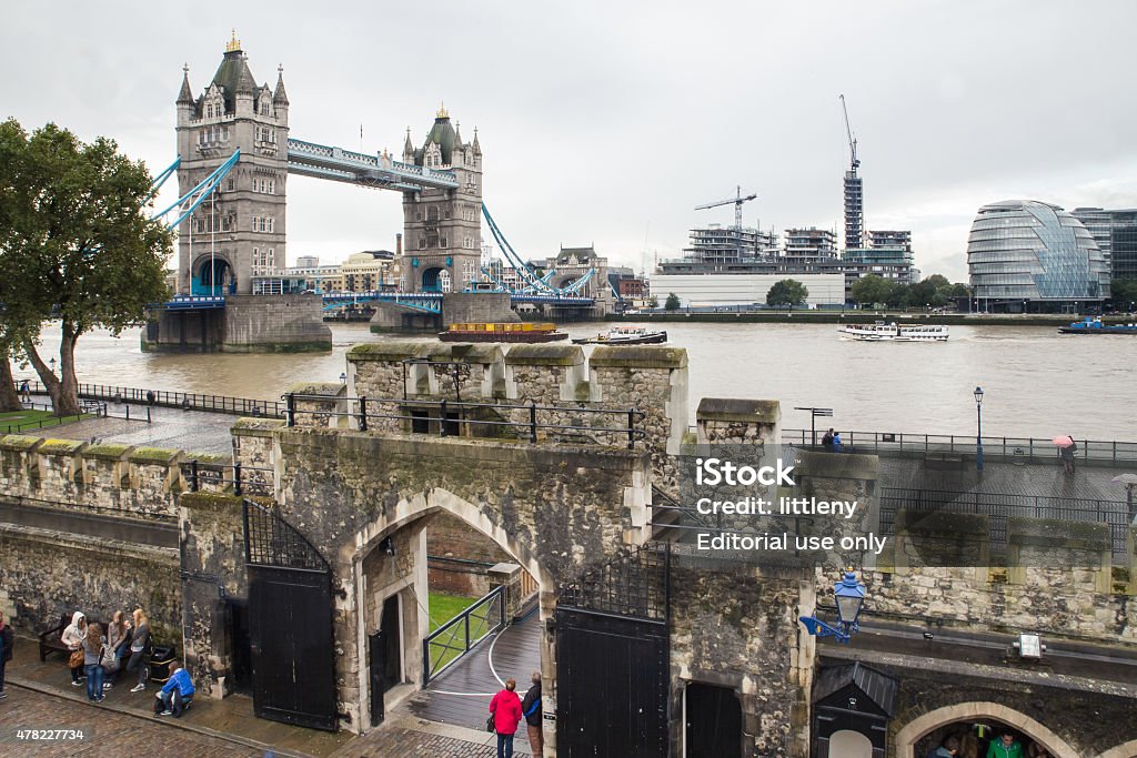 Tower of London and Tower Bridge London, United Kingdom - October 8, 2014:  View from Tower of London with Tower Bridge, Victoria Embankment and people in view.  This historic section of London is one of the city's most visited areas by tourists.  2015 Stock Photo