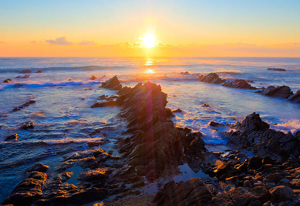 Beautiful sunrise over Cretaceous sedimentary rock coastline