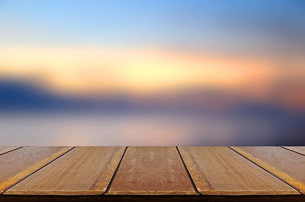 istock Blurred Sunrise Background with Wooden Table. 478230648