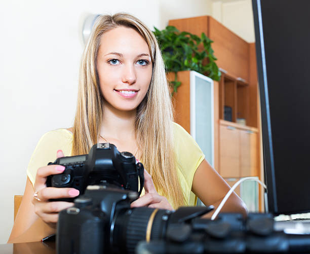istock Smiling girl working with photocamera 478230986