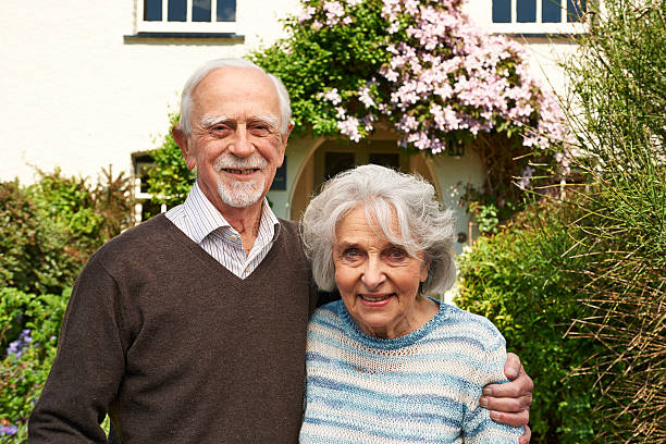 istock Senior Couple Standing Outside Pretty Cottage 478231202