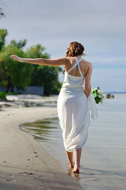 istock bride and groom on the beach 478234173