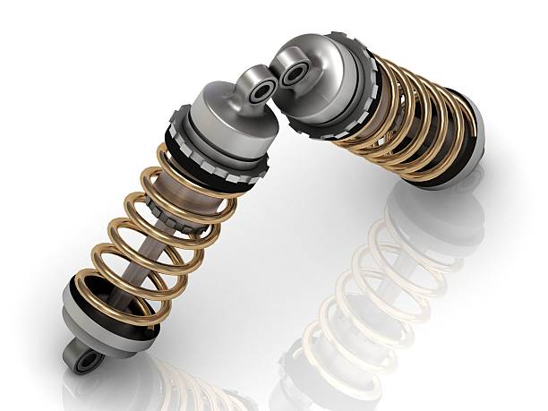 istock Two automotive shock absorber with golden springs 478234176