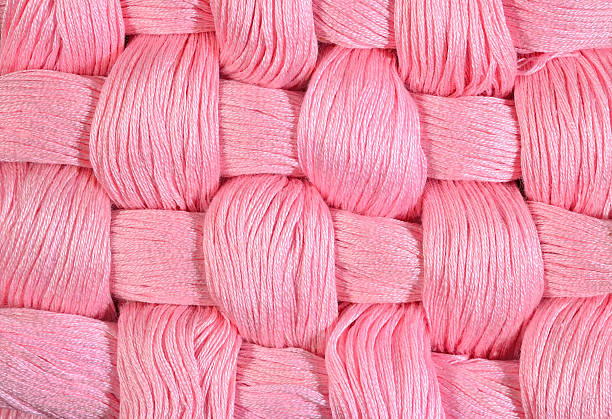 istock Pink twisted skeins of floss as background texture 478234552