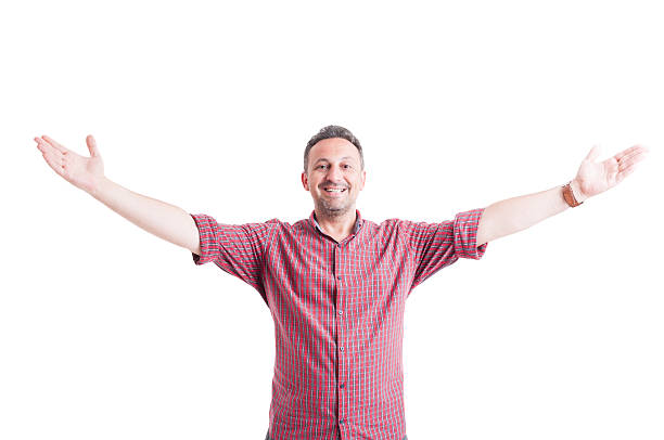 Portrait of cheerful Asian man with hands in the air in front of yellow background