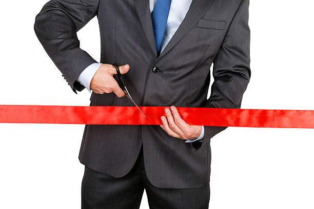 istock Businessman in suit cutting red ribbon 478238802