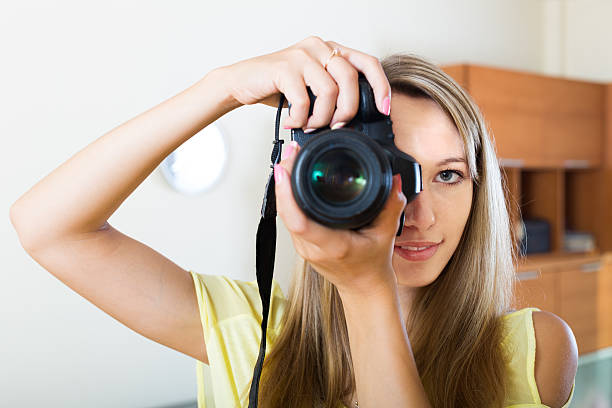 istock smiling girl working with  photocamera 478238902