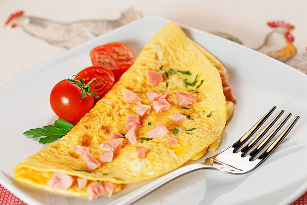 omelette with ham and cherry tomatoes stock photo
