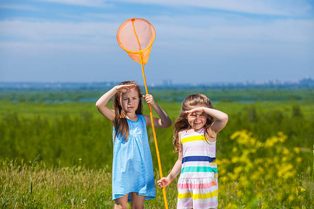 istock Kids summer in the meadow with orange net 478244288