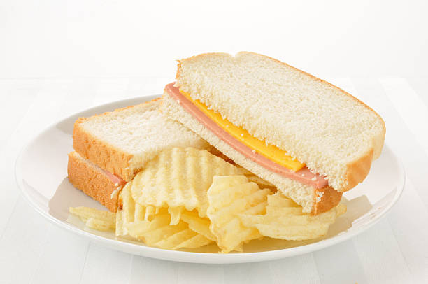 Bologna and cheese sandwich with potato chips