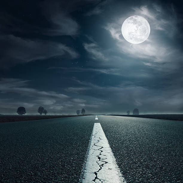 istock Driving on an empty highway towards the full moon 478245003