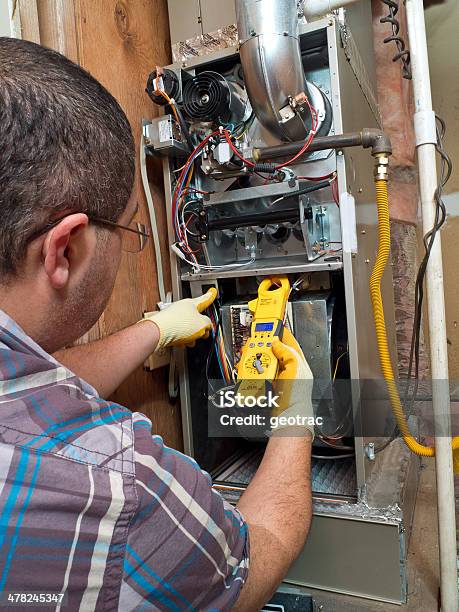 Hispanic Handyman Repairman Conducting Residential Hvac Repair Stock Photo - Download Image Now