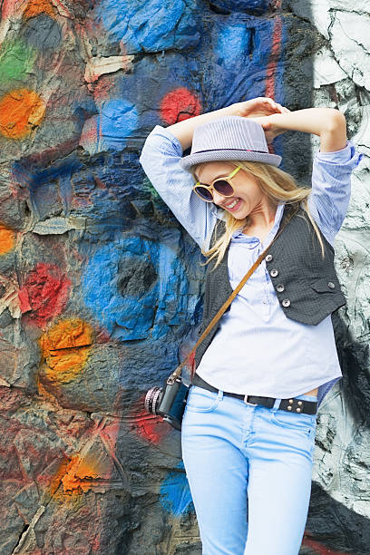 istock smiling hipster girl against urban wall 478246559