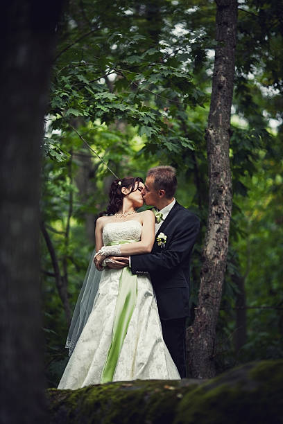 istock wedding. married couple in forest embracing, young groom and bride 478247237