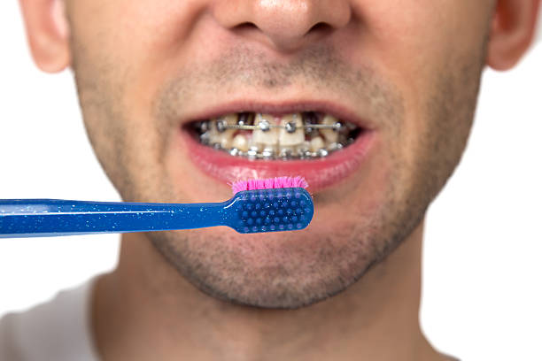 男性写真の歯のクリーニング - smiling human teeth toothbrush moving up ストックフォトと画像