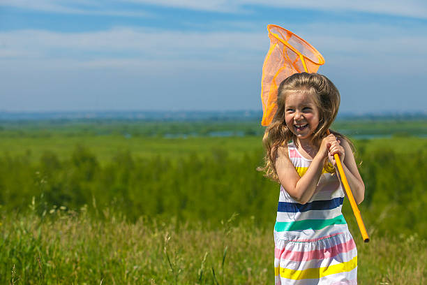 istock Kids summer in the meadow with orange net 478247880