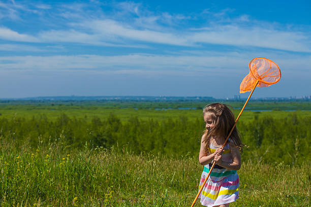 istock Kids summer in the meadow with orange net 478247882