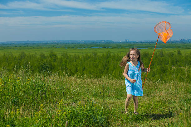Kids summer in the meadow with orange net