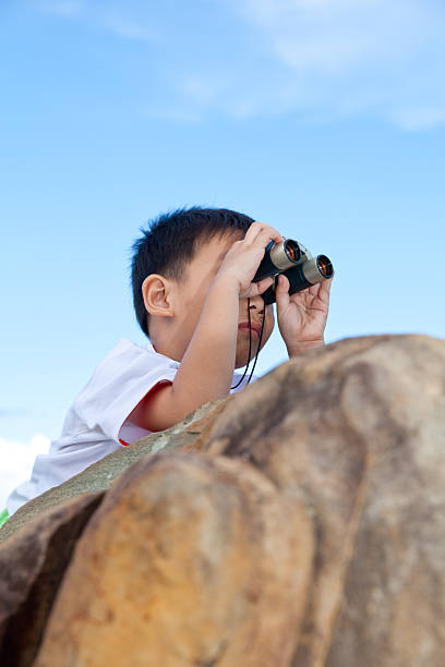 istock Happy little boy exploring outdoors clambering on a rock 478248270