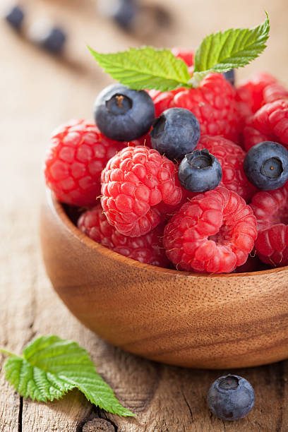 istock fresh berries raspberry blueberry in wooden bowl 478248472
