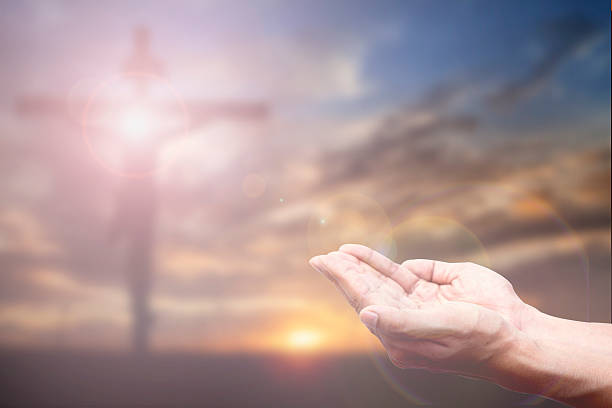 istock Praying Hand and the cross blurred background 478249326