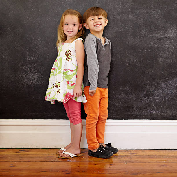 istock Little kids standing in front of blackboard 478252442
