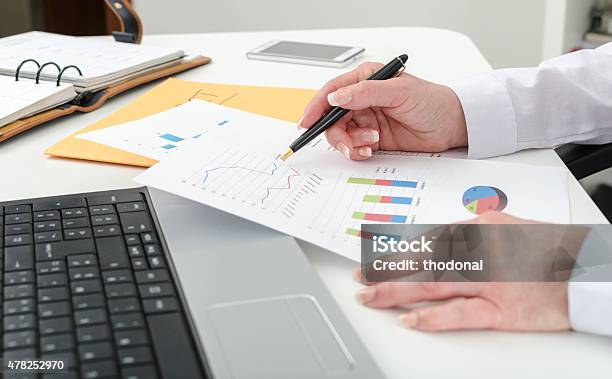 Businesswoman Working On Financial Graphs Stock Photo - Download Image Now - 2015, Adult, Analyzing