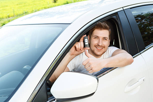 istock Man thumbing up in car with alarm system 478253176
