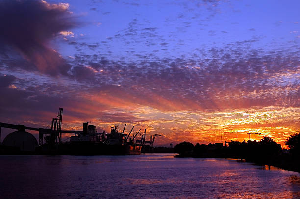 Port of Stockton at Sunset Port of Stockton and turning basin at sunset, public view from Fremont street, Stockton, California. stockton california stock pictures, royalty-free photos & images