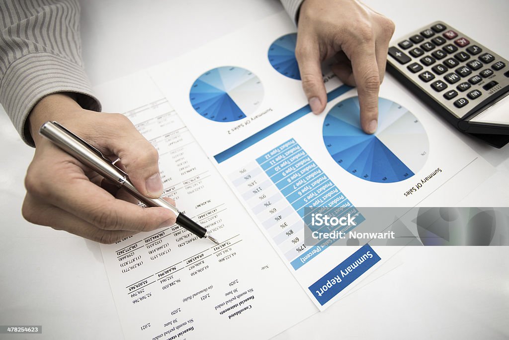 man hand with pen and business report man hand with pen and business report. Accounting Adult Stock Photo