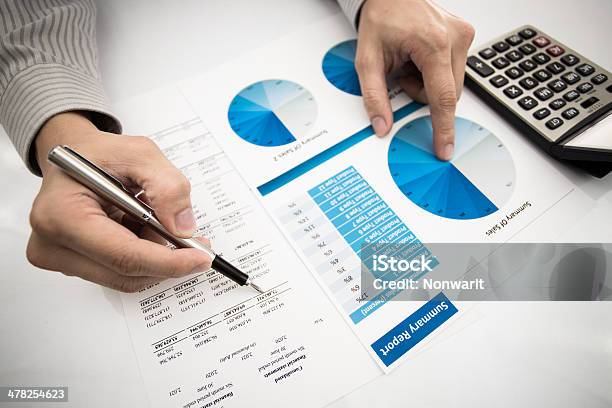 Man Hand With Pen And Business Report Stock Photo - Download Image Now - Adult, Analyzing, Bookmaker